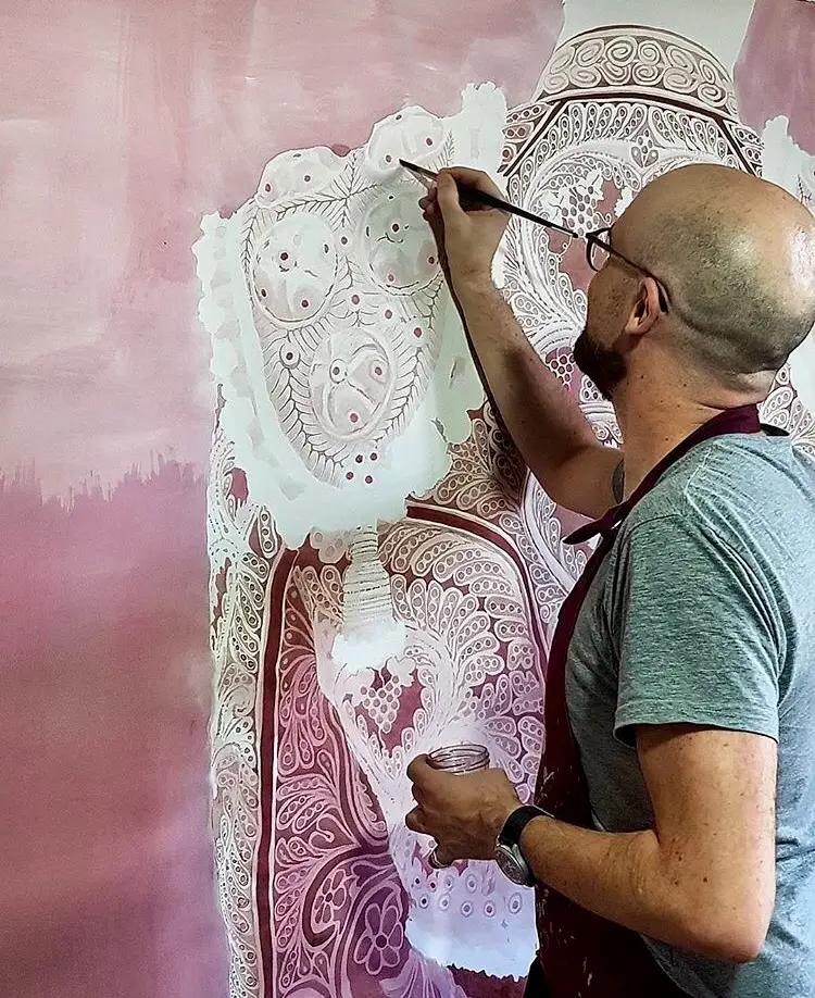 Alfonso Aguirre painting with red wine on paper